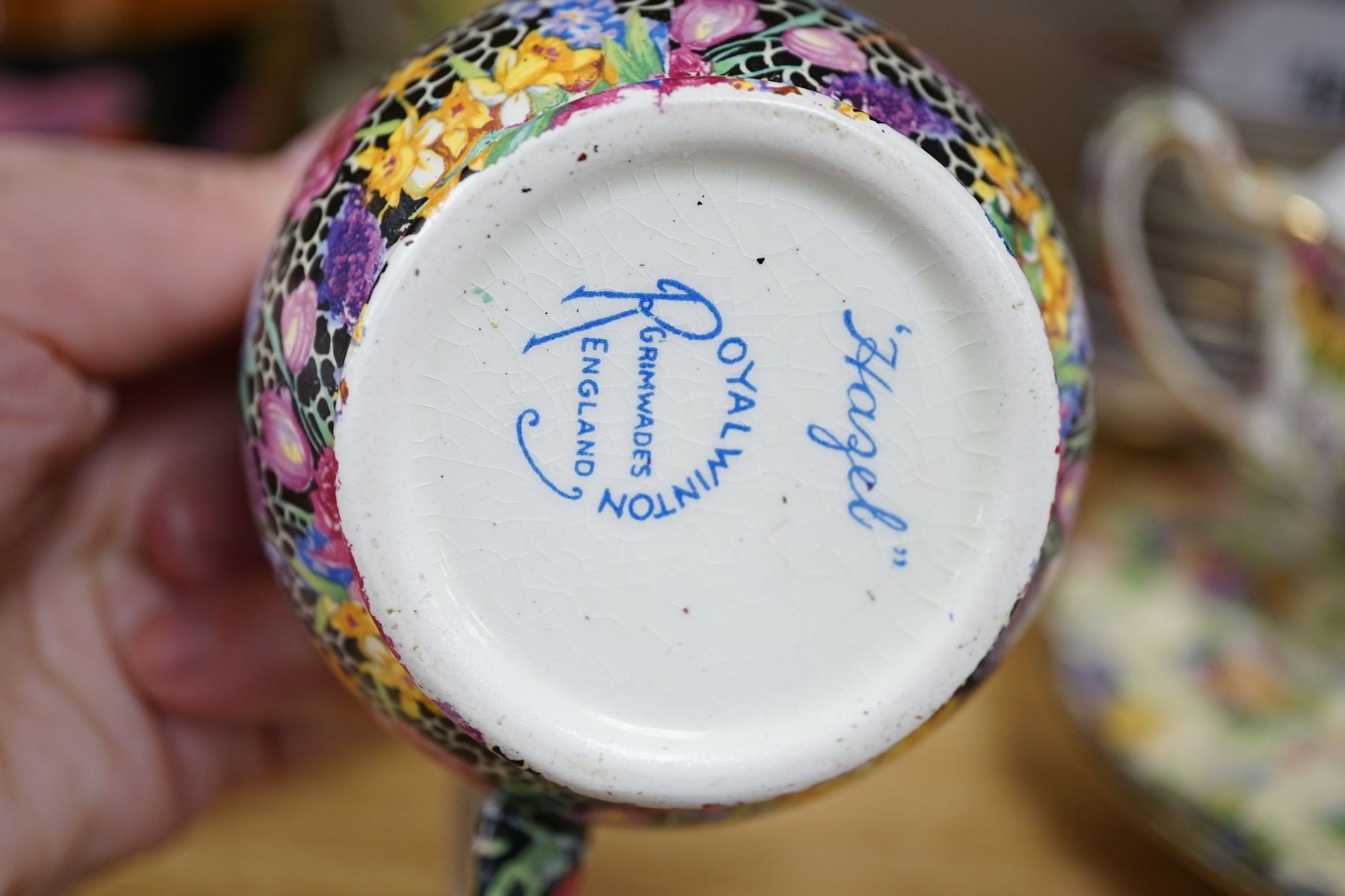 A Clarice Cliff tea cup, a collection of chintz patterned teaware, a lustre bowl and a honey pot and cover